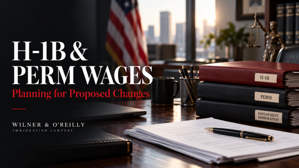 Salary planning documents and employment case folders on a desk illustrating proposed H-1B and PERM wage changes